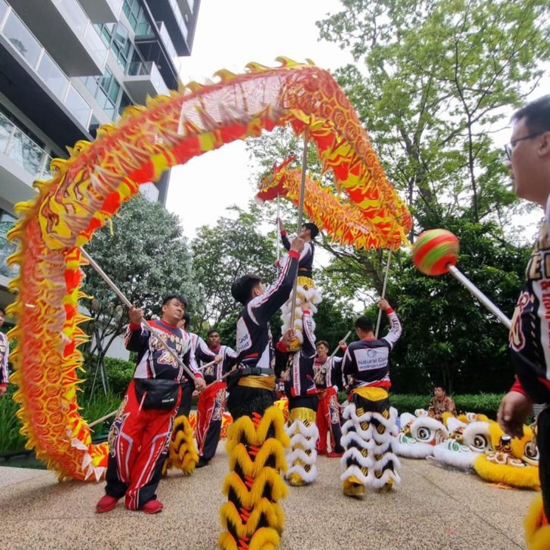 Dragon dance troupe performing outdoors in Southeast Asia