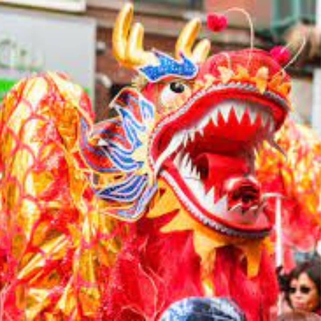 Red and gold dragon dance costume at a celebration in Southeast Asia