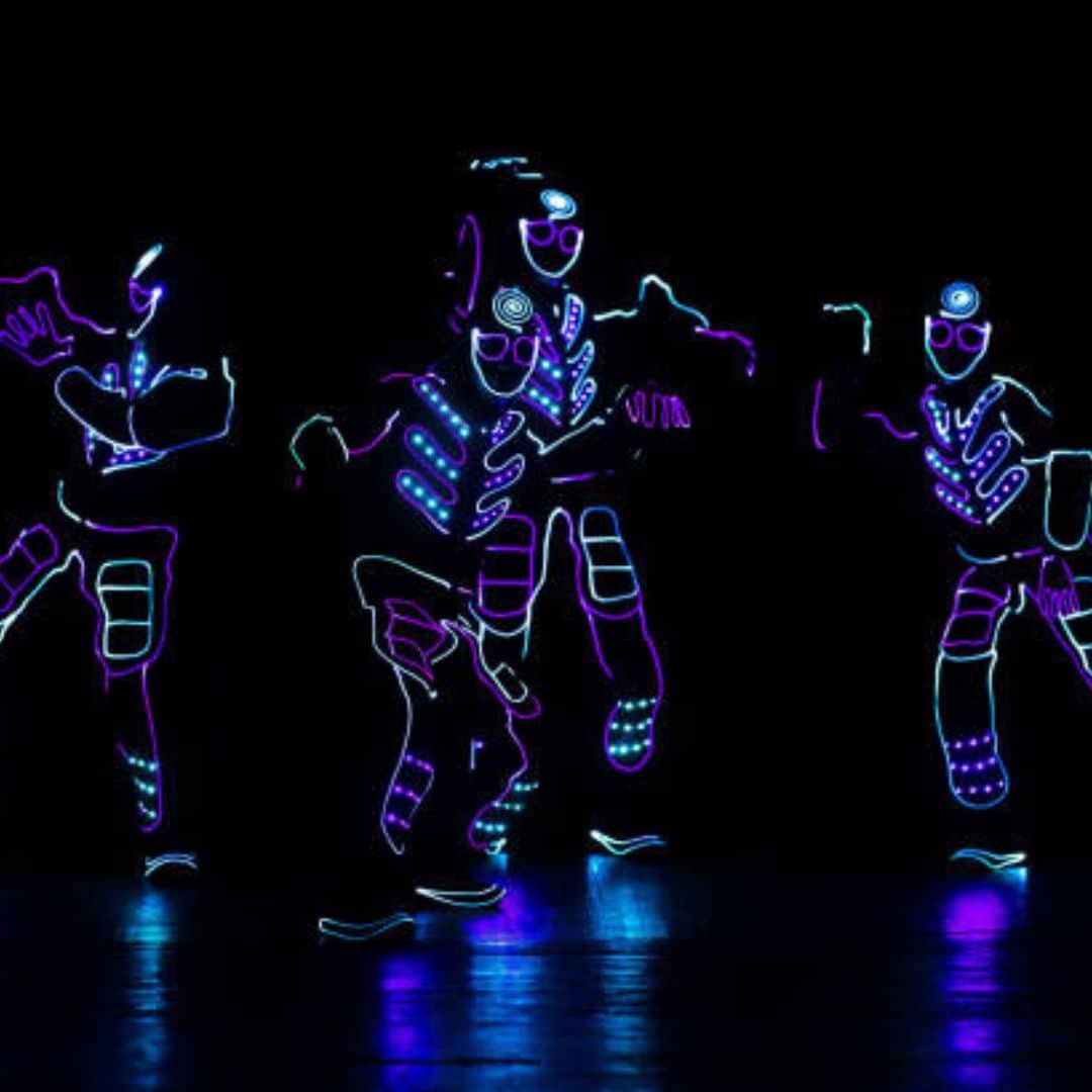 LED robot dancers in glowing suits in Southeast Asia