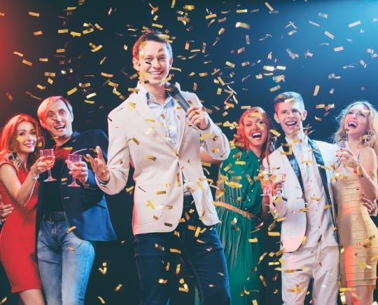 Emcee celebrating with party guests in Southeast Asia