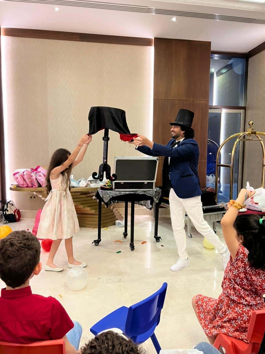 Magician with a young volunteer at a kids party in Southeast Asia Magician with a young volunteer at a kids party in Southeast Asia