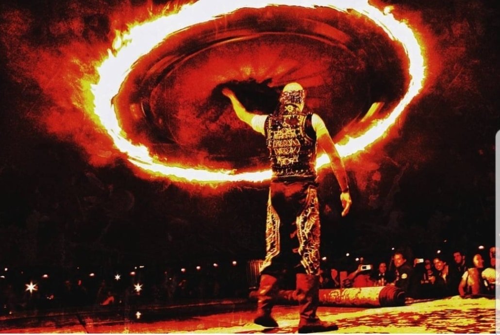 Fire tanoura performer on stage in Southeast Asia