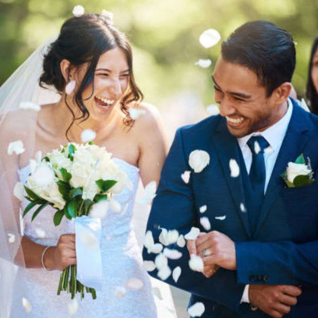 Bride and groom walking through flower petals in Southeast Asia Bride and groom walking through flower petals in Southeast Asia