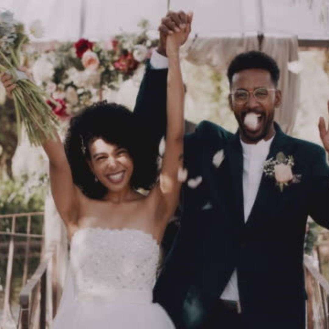 Newlyweds celebrating with raised hands in Southeast Asia Newlyweds celebrating with raised hands in Southeast Asia